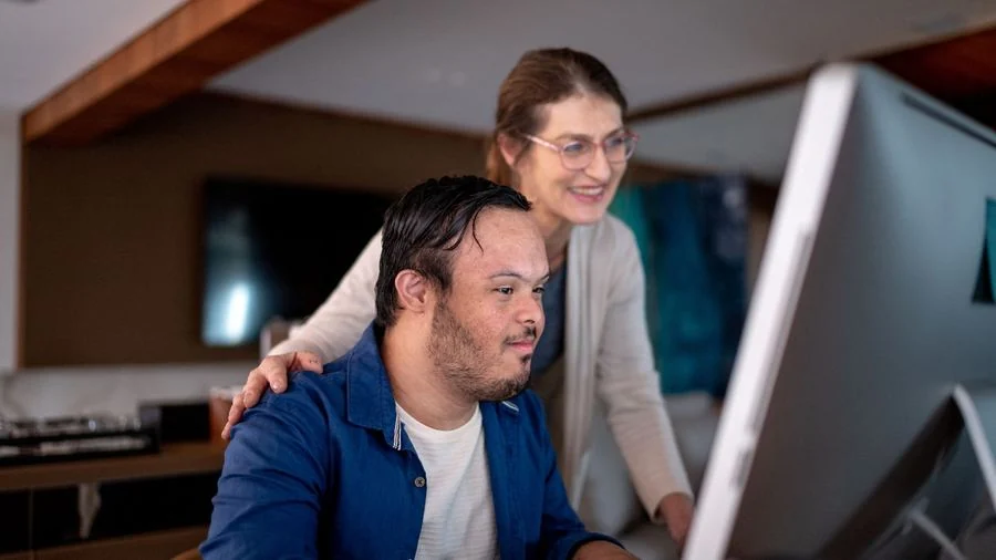 Support worker assisting participant at home